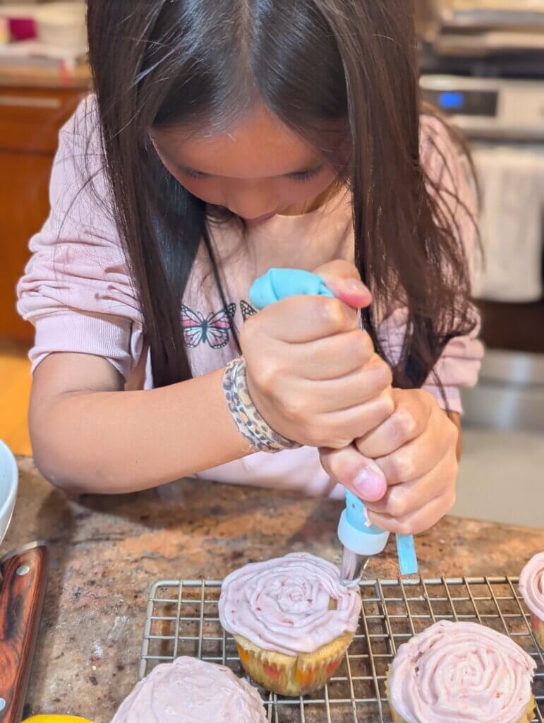 My daughter's favorite part - piping the cupcakes