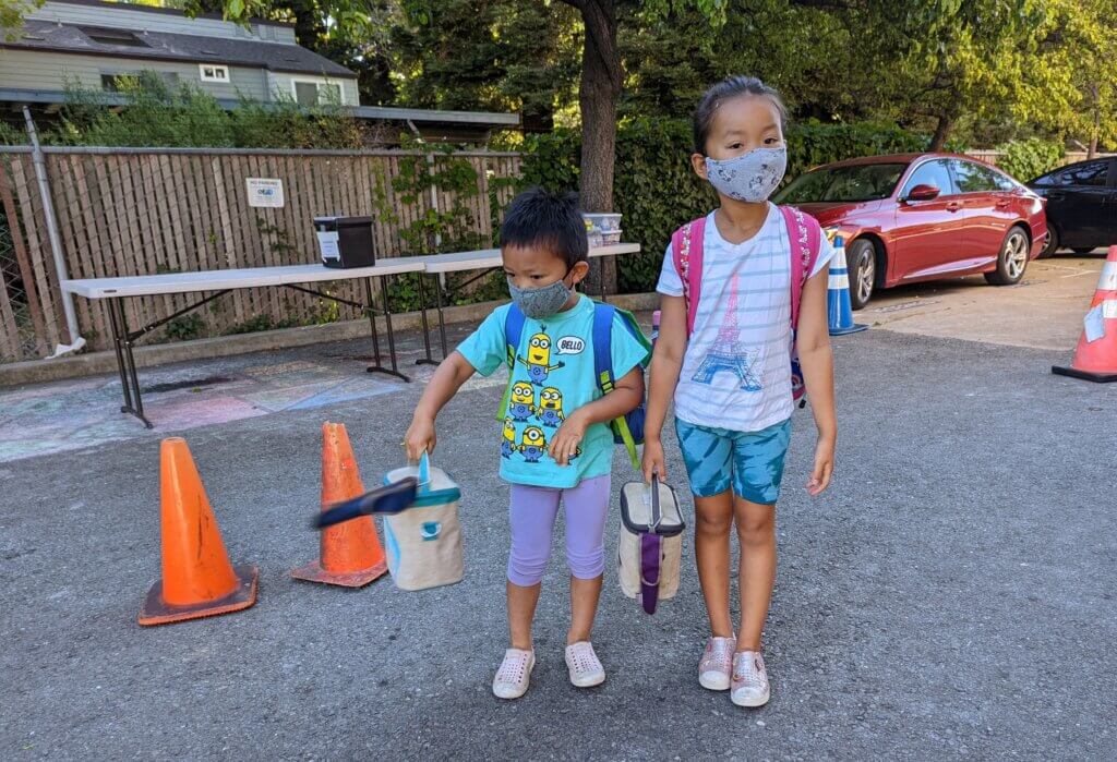 My kids, almost 4 and 6 then, at a gymnastic's parking lot for summer camp