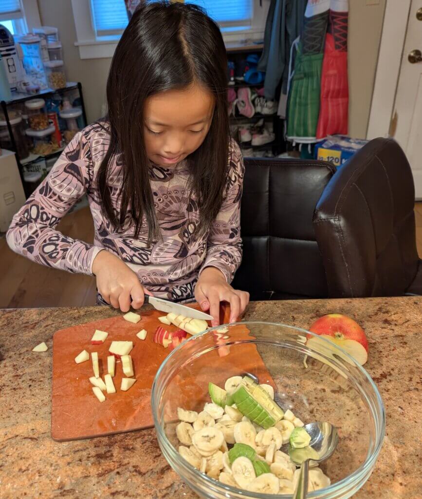 Making herself a fruit salad